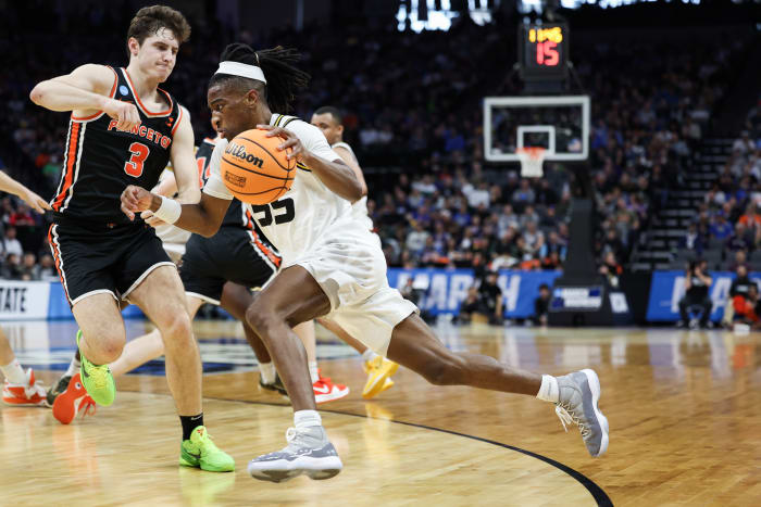 Missouri Tigers guard Sean East II dribbles past Princeton Tigers guard Ryan Langborg.